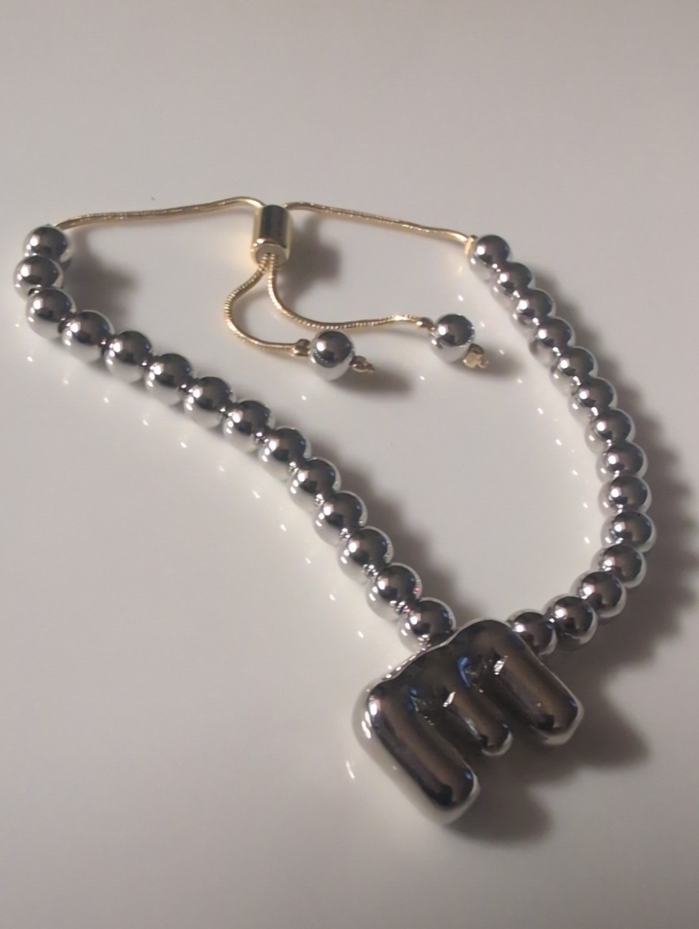 Silver Beaded Bracelet with SilverTone Puffy Charm And Gold Metal Slider Closure